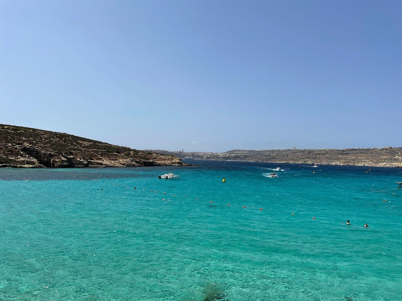 The Blue Lagoon — turquoise water over white sand between Comino and Cominotto