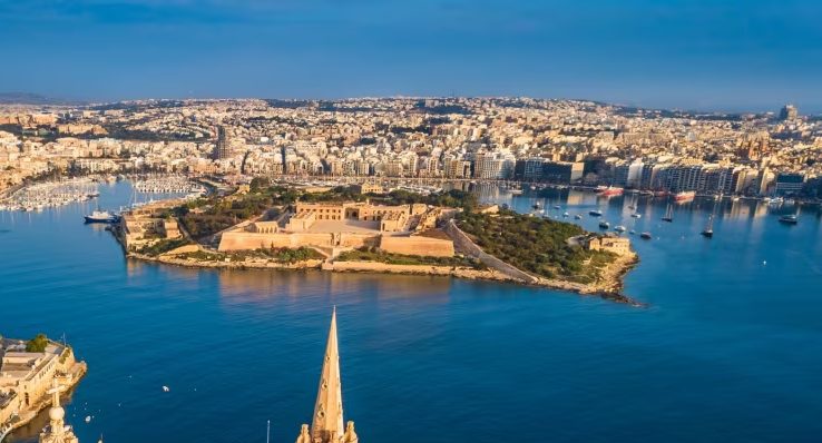 Sailing past Fort Manoel in Marsamxett Harbour, with the Sliema waterfront beyond